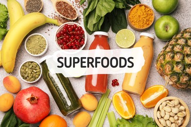 Image of Superfoods. Healthy smoothies in glass bottles and ingredients on table, top view
