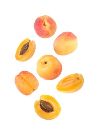 Image of Fresh juicy apricots in air against white background