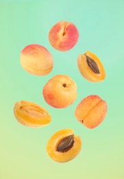 Image of Fresh juicy apricots in air against color gradient background