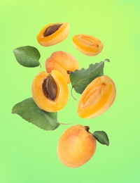 Image of Fresh juicy apricots in air against color background background