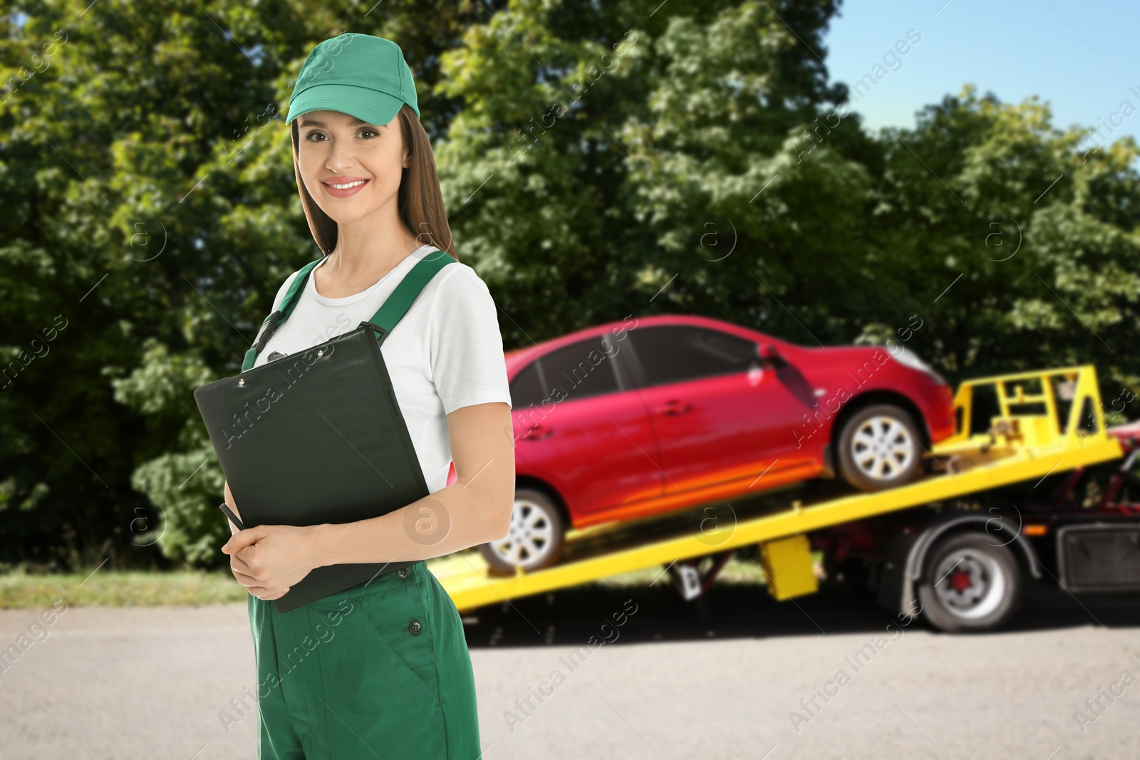 Car service worker with clipboard near red auto and tow truck outdoors Image of Car service worker with clipboard near red auto and tow truck outdoors
