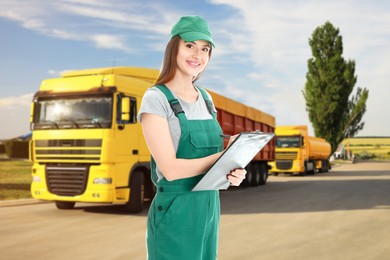 Image of Car service worker with clipboard and trucks outdoors