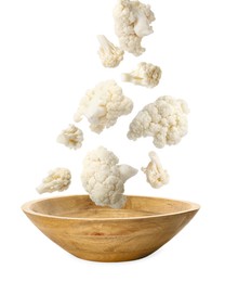 Image of Cauliflower florets falling into bowl against white background