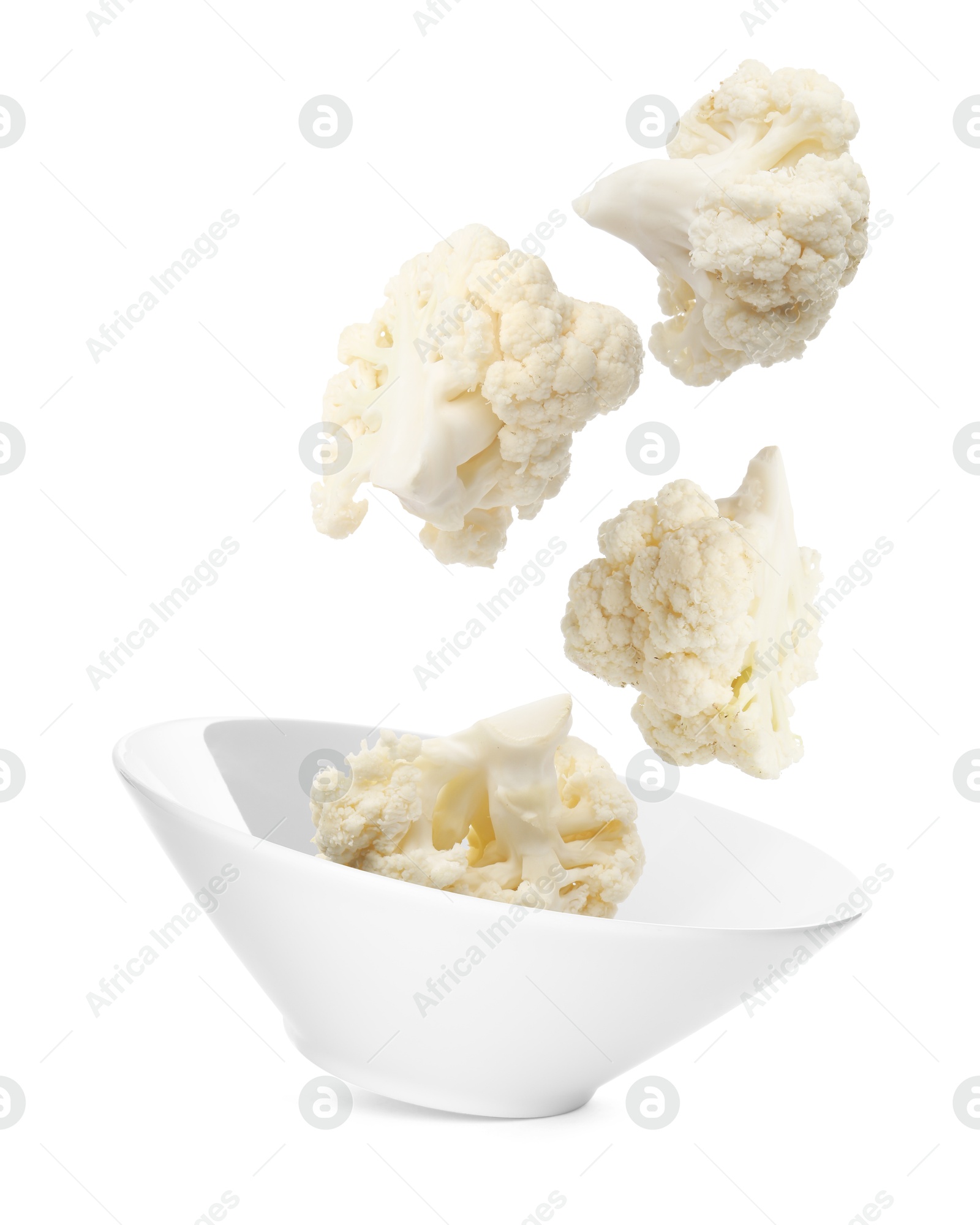 Image of Cauliflower florets and bowl in air against white background
