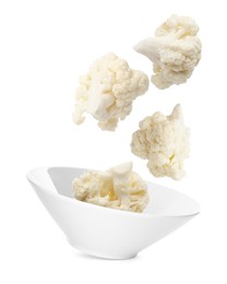 Image of Cauliflower florets and bowl in air against white background