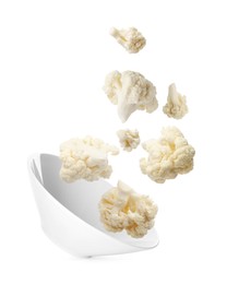 Image of Cauliflower florets and bowl in air against white background