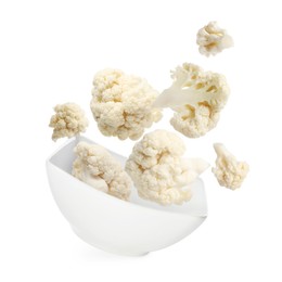 Image of Cauliflower florets and bowl in air against white background