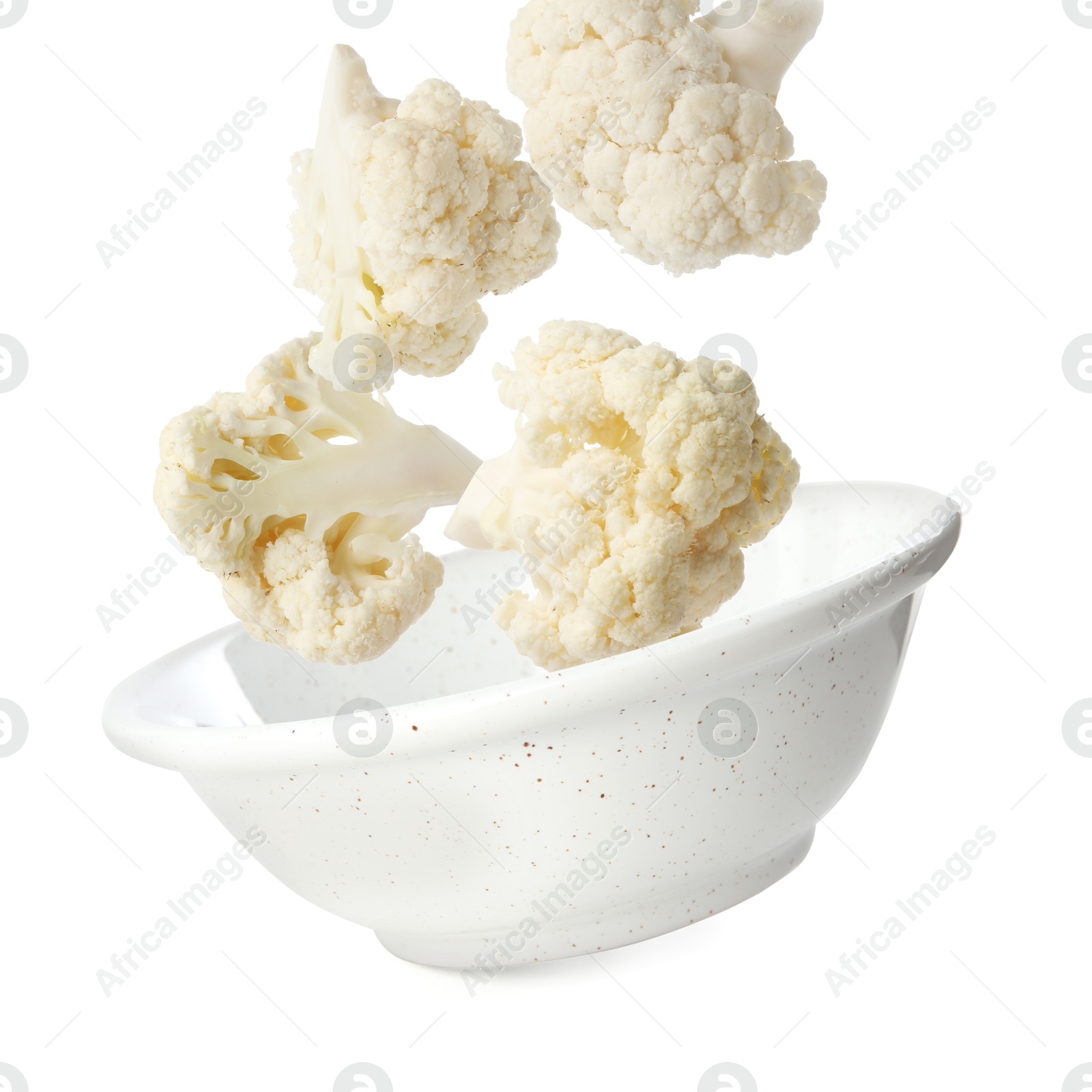 Image of Cauliflower florets and bowl in air against white background