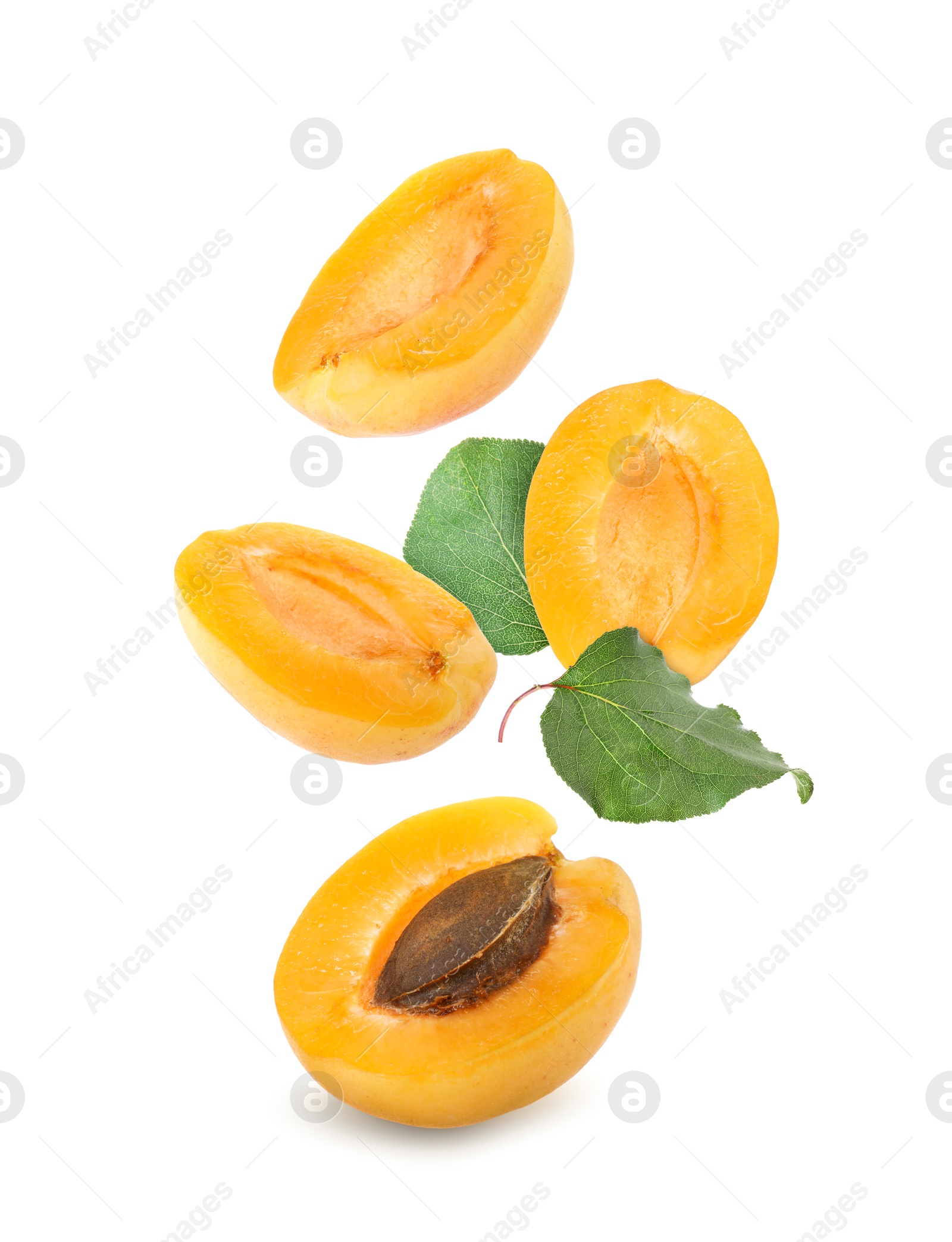 Image of Fresh juicy apricots falling against white background
