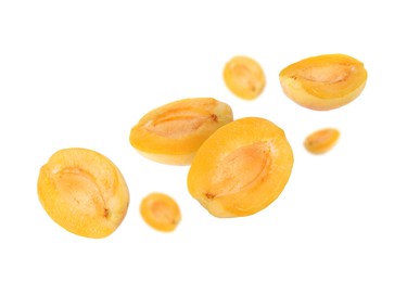 Image of Fresh juicy apricot halves flying against white background