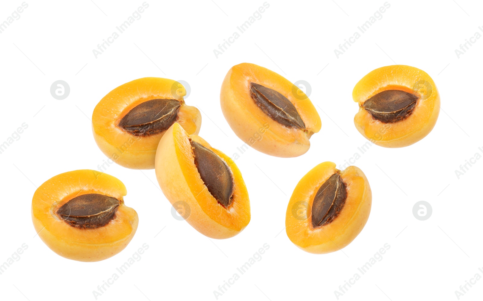 Image of Fresh juicy apricot halves flying against white background