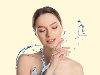 Image of Woman with smooth skin and water splash against beige background