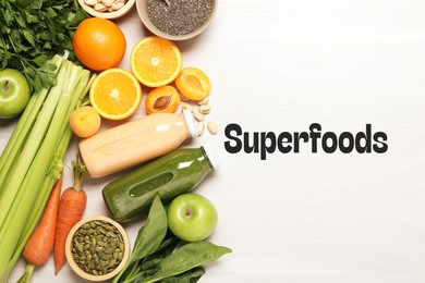 Image of Superfoods. Healthy smoothies in glass bottles and ingredients on table, top view