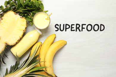 Image of Superfood. Healthy smoothie in glass bottle and ingredients on white table, top view