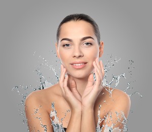 Image of Woman with smooth skin and water splash against grey background