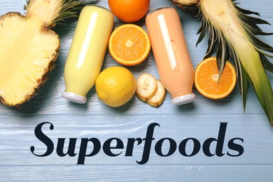 Image of Superfoods. Healthy smoothies in glass bottles and ingredients on wooden table, top view
