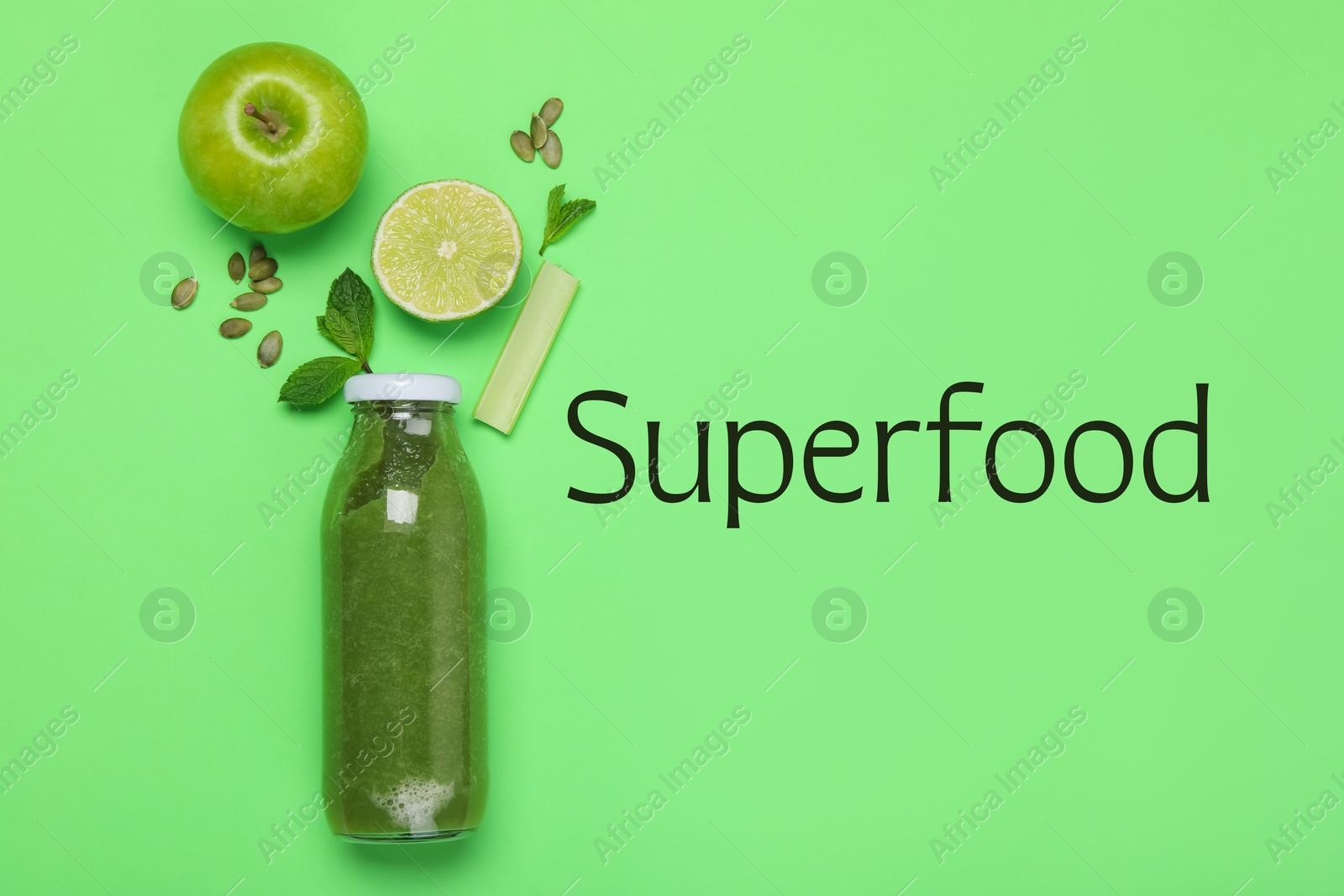 Image of Superfood. Healthy smoothie in glass bottle and ingredients on green background, top view