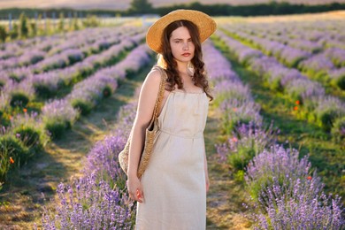 Photo of Portrait of beautiful young woman in lavender field