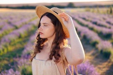 Photo of Portrait of beautiful young woman in lavender field