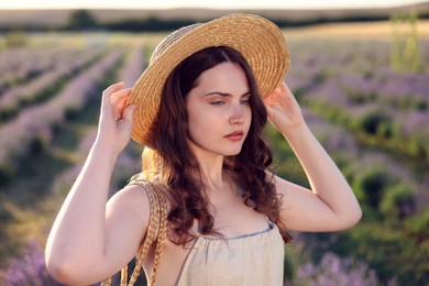 Photo of Portrait of beautiful young woman in lavender field