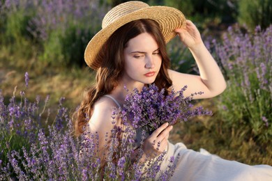 Photo of Beautiful young woman with lavender flowers in field