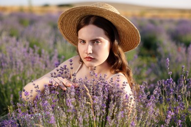 Photo of Beautiful young woman among lavender flowers in field