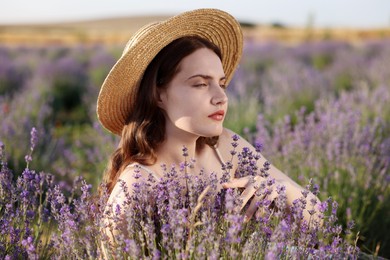 Photo of Beautiful young woman among lavender flowers in field