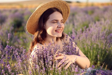 Photo of Beautiful young woman among lavender flowers in field