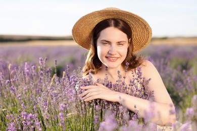 Photo of Beautiful young woman among lavender flowers in field