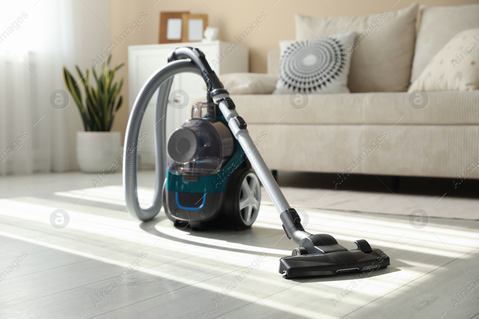 One vacuum cleaner on floor indoors. Household appliance Photo of One vacuum cleaner on floor indoors. Household appliance