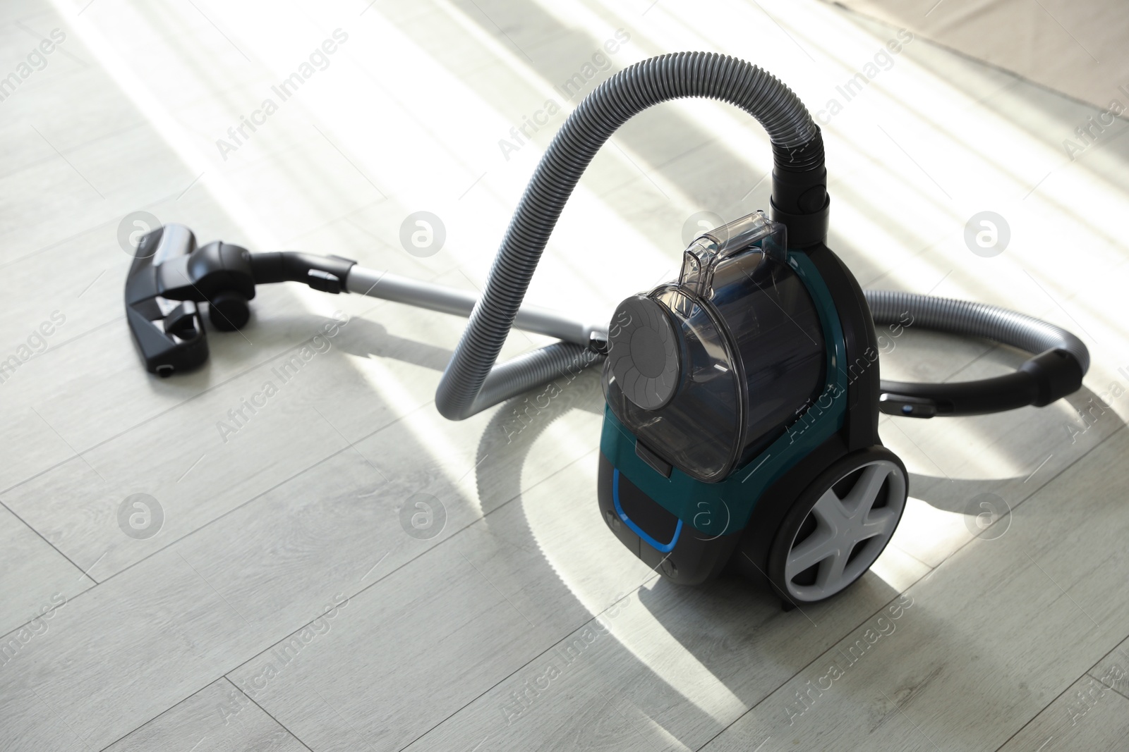 One vacuum cleaner on floor indoors. Household appliance Photo of One vacuum cleaner on floor indoors. Household appliance