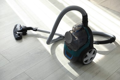 Photo of One vacuum cleaner on floor indoors. Household appliance