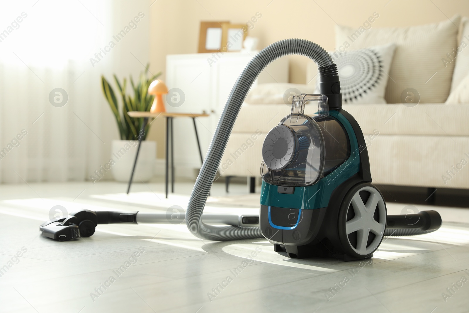 One vacuum cleaner on floor indoors. Household appliance Photo of One vacuum cleaner on floor indoors. Household appliance