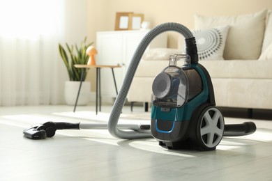 Photo of One vacuum cleaner on floor indoors. Household appliance