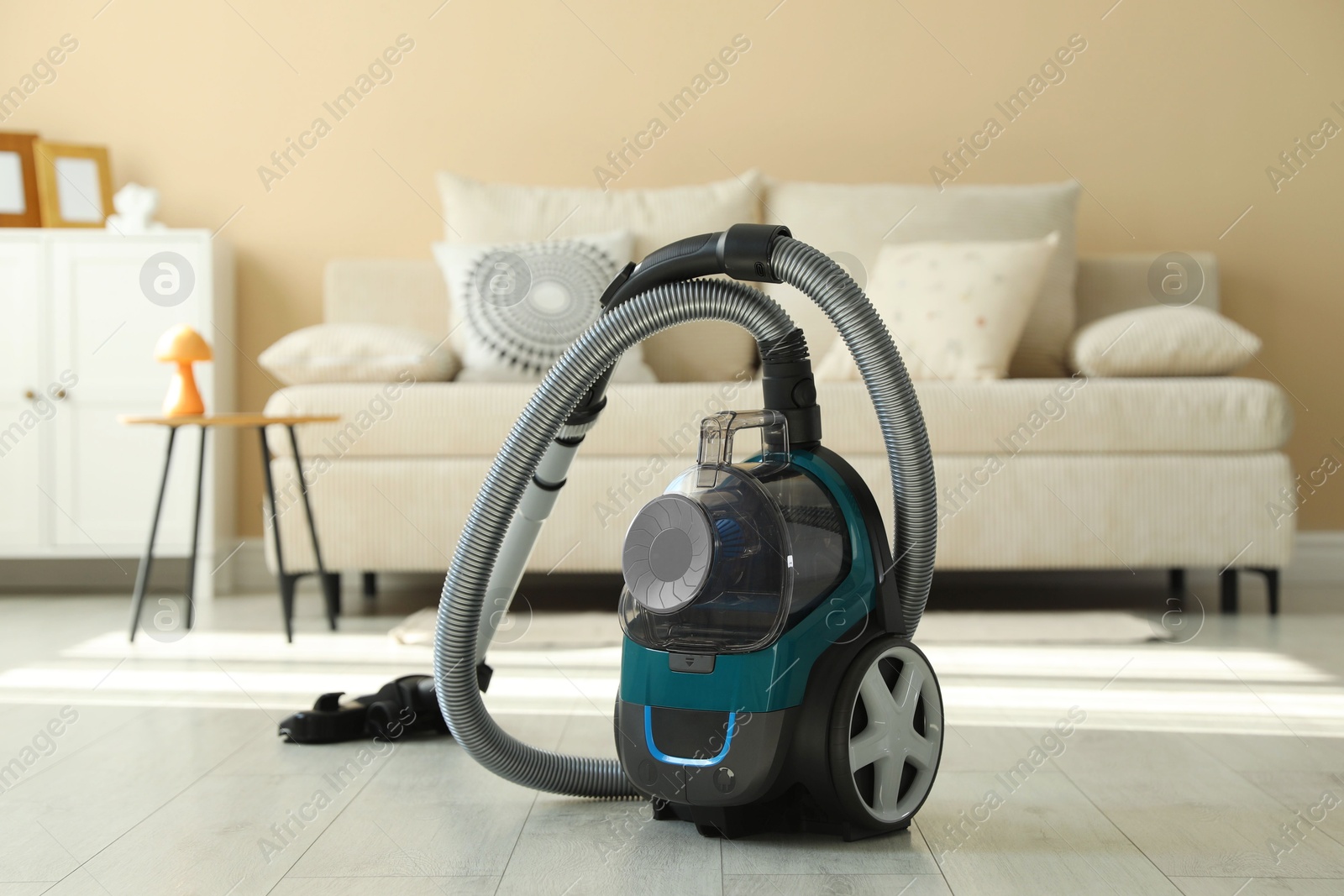 One vacuum cleaner on floor indoors. Household appliance Photo of One vacuum cleaner on floor indoors. Household appliance