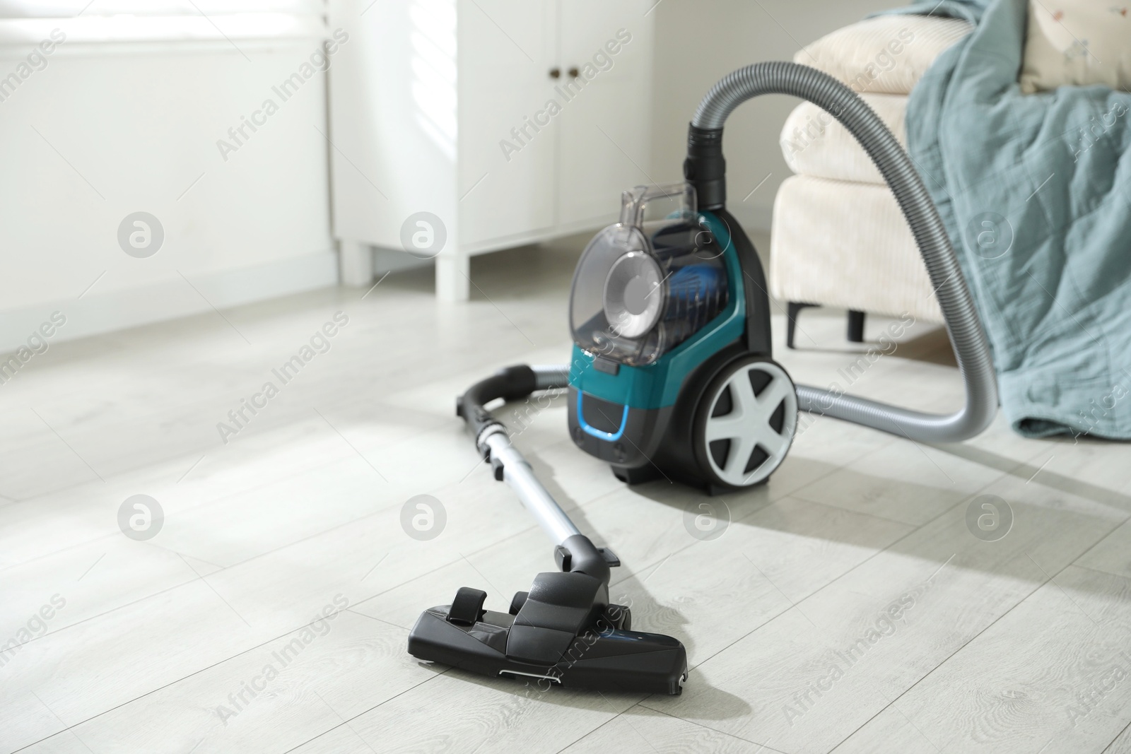 One vacuum cleaner on floor indoors. Household appliance Photo of One vacuum cleaner on floor indoors. Household appliance
