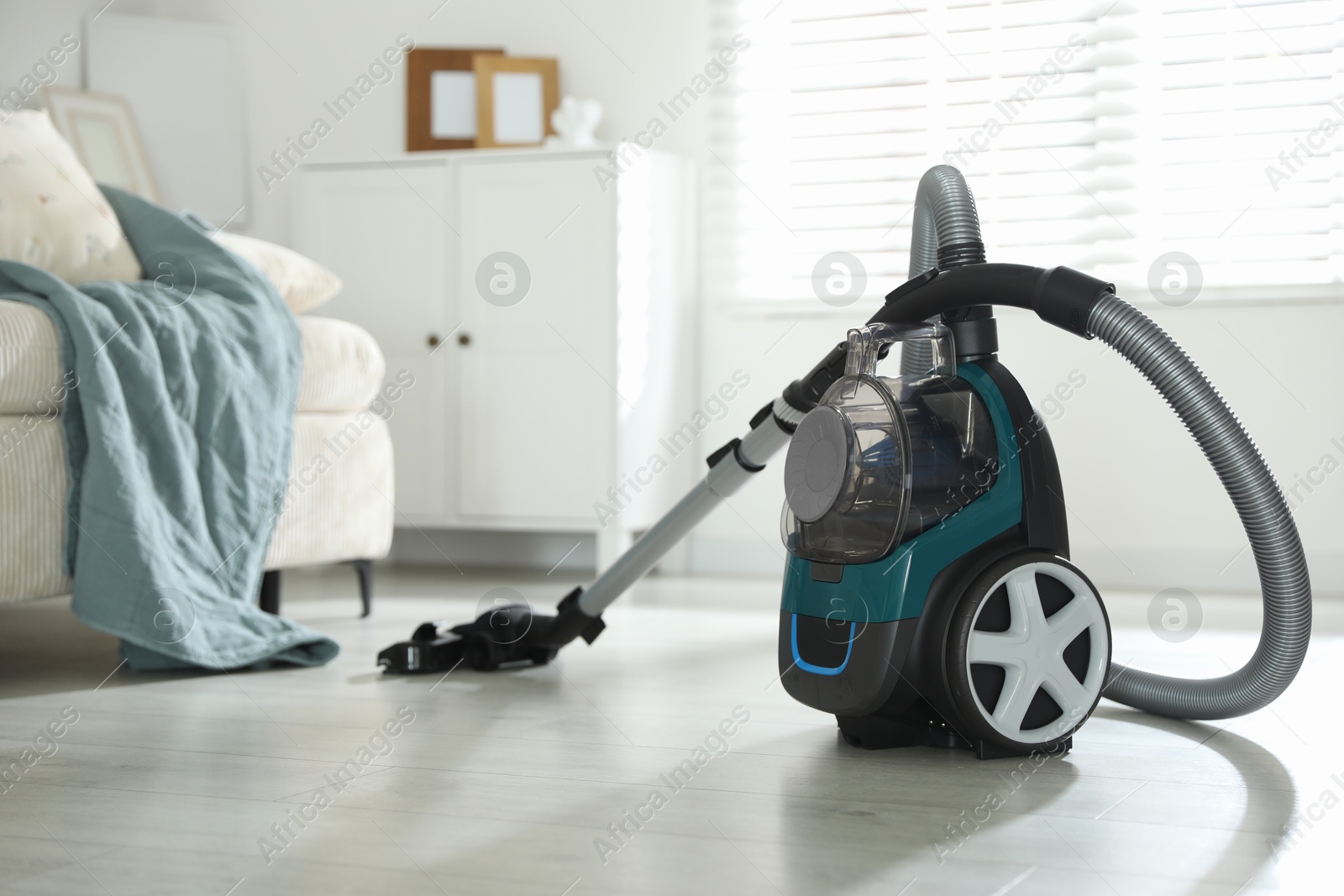 One vacuum cleaner on floor indoors. Household appliance Photo of One vacuum cleaner on floor indoors. Household appliance