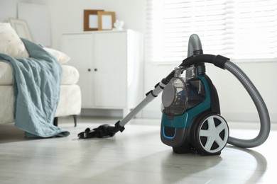 Photo of One vacuum cleaner on floor indoors. Household appliance