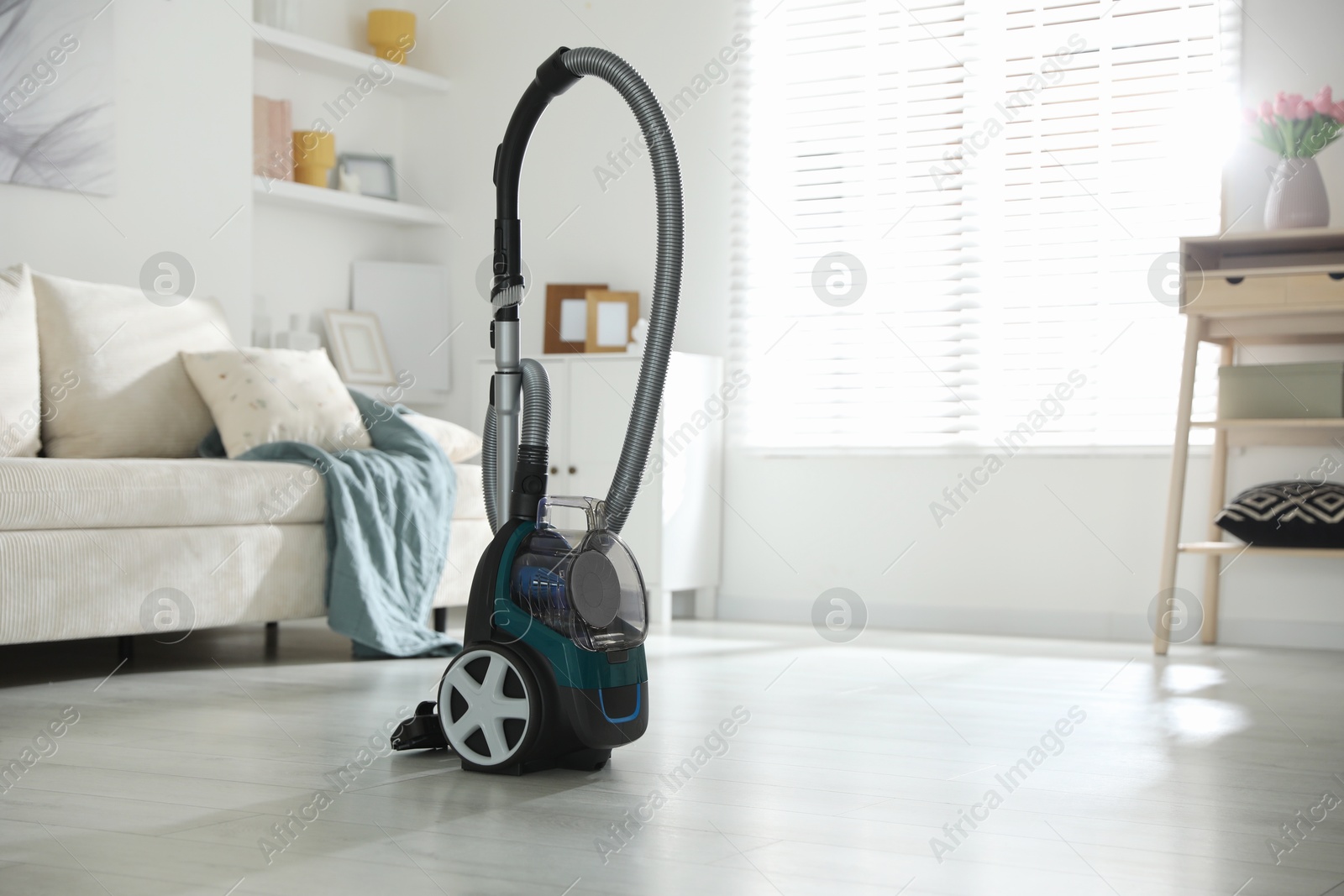 One vacuum cleaner on floor indoors. Household appliance Photo of One vacuum cleaner on floor indoors. Household appliance