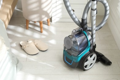 Photo of One vacuum cleaner on floor indoors. Household appliance