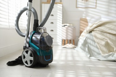 Photo of One vacuum cleaner on floor in bedroom. Space for text