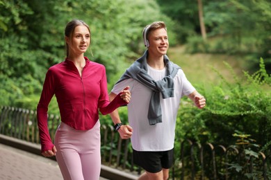 Photo of Happy couple running in park. Morning exercise