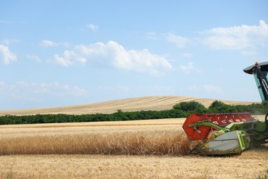 Photo of Modern combine harvester working in wheat field