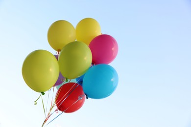 Photo of Bunch of colorful balloons under beautiful sky, low angle view