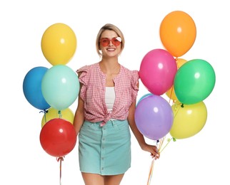 Photo of Smiling woman in sunglasses with bunches of colorful balloons on white background