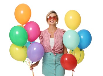 Photo of Smiling woman in sunglasses with bunches of colorful balloons on white background