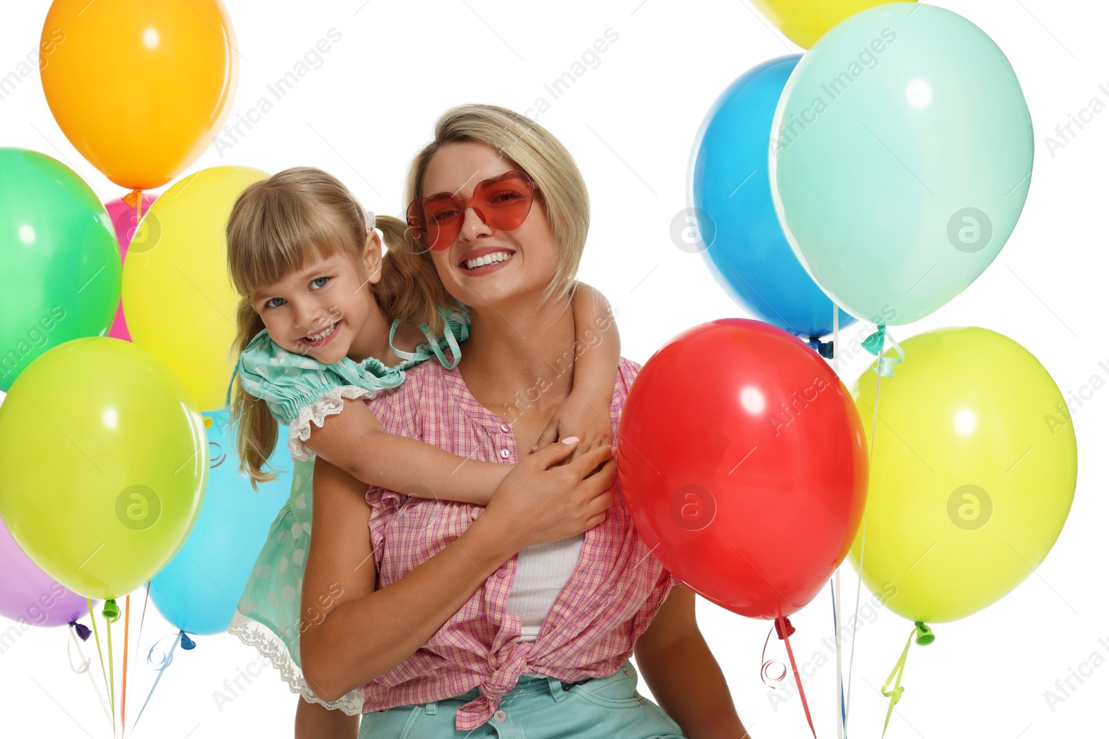 Photo of Happy mother in sunglasses and her little daughter with bunches of colorful balloons on white background