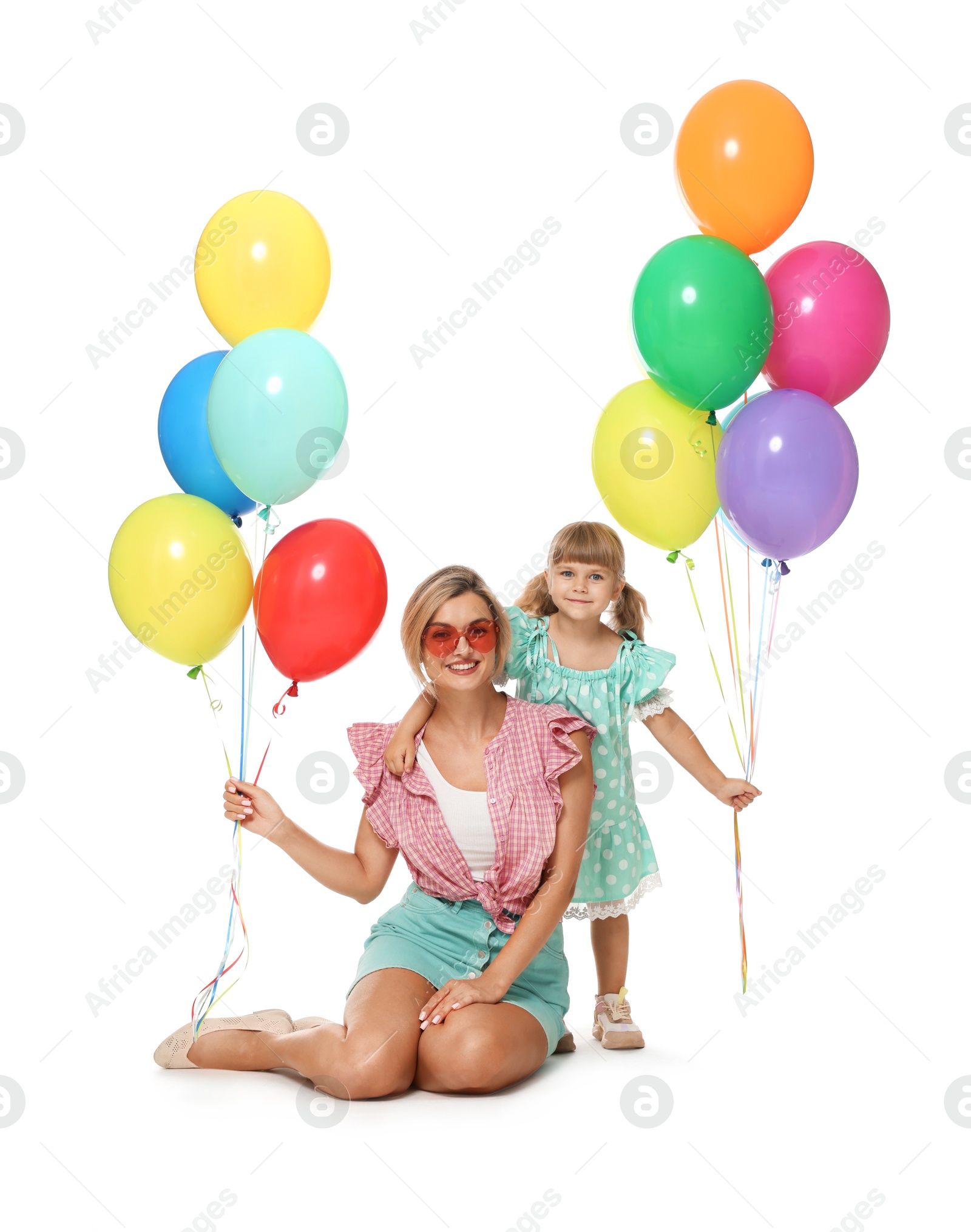 Happy mother in sunglasses and her little daughter with bunches of colorful balloons on white background Photo of Happy mother in sunglasses and her little daughter with bunches of colorful balloons on white background