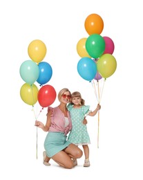 Photo of Happy mother in sunglasses and her little daughter with bunches of colorful balloons on white background