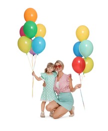Photo of Happy mother in sunglasses and her little daughter with bunches of colorful balloons on white background
